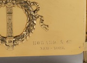 An antique French brass-cased figural mantle clock with chariot scene, eight day time and bell striking movement with applied enamel Roman numerals, retailed by HOWARD & Co. of New York, late 19th century, together with a pair of figural candelabra garnit - 2