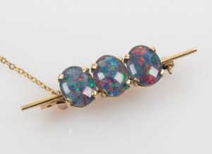 A 9ct gold brooch, set with three opal doublets, 4cm wide