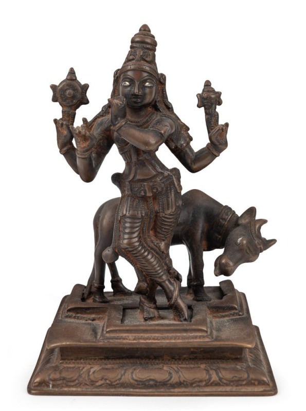 An antique Indian cast bronze figural statue of Krishna and bull, 19th century, note: silver inlay to the eyes, ​​​​​​​15cm high