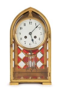 An antique French mantle clock in brass lancet top case with ruby and clear glass checkerboard motif, eight day time and strike movement with mercury pendulum, 19th century, 30cm high