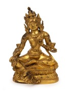 An antique Tibetan gilt bronze green tara figure, wearing a finely cast five-pronged crown, earrings and necklaces, with down cast eyes in serene expression, 19th century, the base marked with an engraved Tibetan thunder bolt. ​​​​​​​16cm high