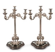 A stunning pair of Elkington antique English silver-plated candelabra with griffin decoration, together with mirrored silver-plated stands, also by Elkington, 19th century (four items). PROVENANCE: Ex Myers boardroom, Melbourne, 75cm high each overall&nbsp;