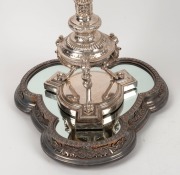 A stunning pair of Elkington antique English silver-plated candelabra with griffin decoration, together with mirrored silver-plated stands, also by Elkington, 19th century (four items). PROVENANCE: Ex Myers boardroom, Melbourne, 75cm high each overall&nbsp; - 4