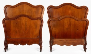 A pair of antique French mahogany single beds, 19th century, with later slats and rails, 140cm high, 102cm wide, 190cm long