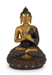 An antique Sino-Tibetan seated Buddha statue, gilt bronze with silver and copper decoration, hands in a Dharmachakra-mudra position in front of his chest with a square-shaped flower pattern of repousse and scroll work decoration to the robe, seated in dhy