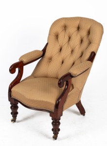 An antique Australian Colonial cedar easy chair with scroll arms, turned front legs with castors and diamond button upholstery, 19th century