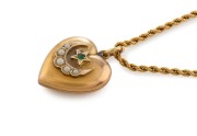 A yellow gold rope twist muff chain with an antique 9ct gold heart shaped pendant, set with seed pearls and emerald, 132cm long, 24 grams total