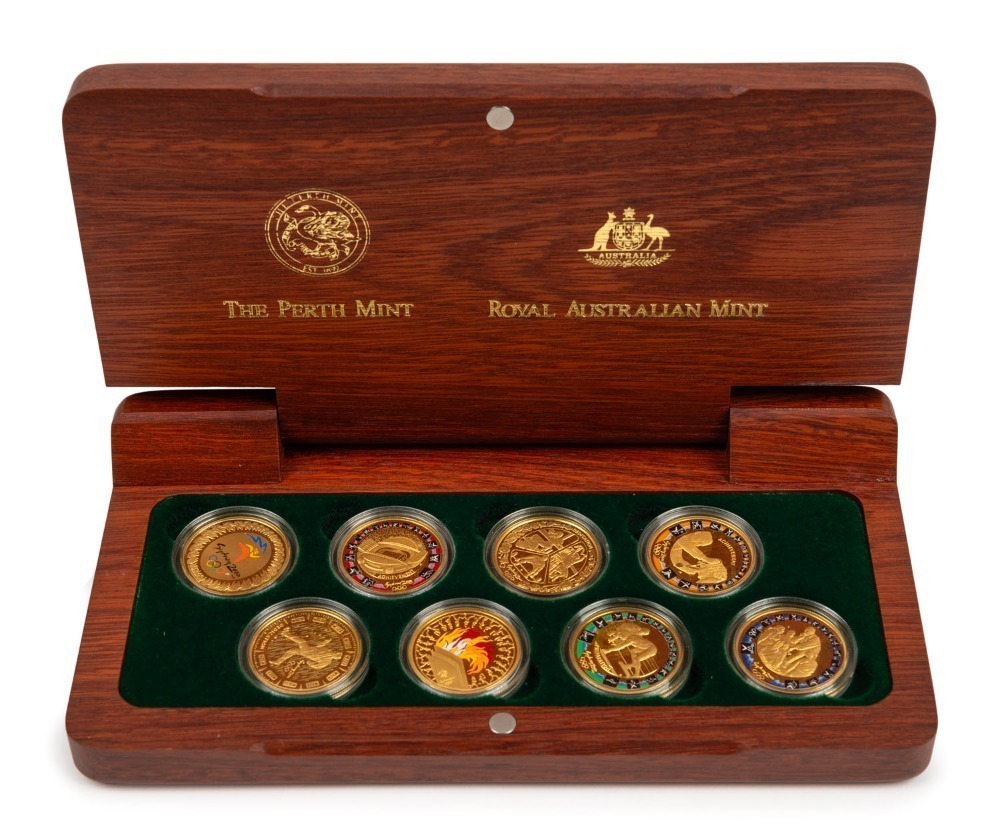 THE SYDNEY 2000 OLYMPIC $100 GOLD COIN collection of 8 coins in a  gold-embossed Jarrah