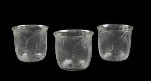 LALIQUE group of three French glasses with shell decoration and black enamel designs to the bases, engraved "R. LALIQUE, FRANCE", 5cm high