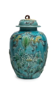 An antique Chinese turquoise glaze vase and cover with applied chrysanthemum&nbsp;and gourd decoration, 19th century, impressed square seal mark to base, 21cm high overall