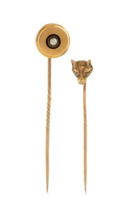 Two antique yellow gold stickpins, one in the form of a fox head with diamond eyes, the other target form, set with a seed pearl, 19th century, 5cm and 6cm long, 4.9 grams total