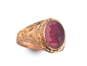 A 9ct gold signet ring with intaglio cut red stone classical portrait, 19th/20th century, stamped "9ct J.M.K.", 7.1 grams