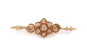 An antique 18ct yellow gold bar brooch set with 9 rose cut diamonds (approximately 0.66ct total), circa 1880, 5.6cm wide, 10.1 grams