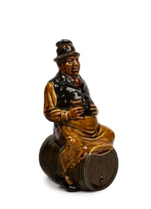 ROYAL DOULTON KINGSWARE&nbsp;man on a barrel&nbsp;whisky flagon with original stopper, early 20th century, black factory mark to base, 24cm high