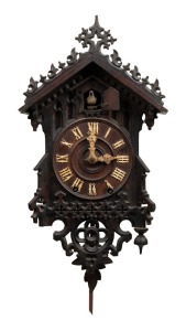 An antique Black Forest cuckoo wall clock with original wooden framed spring driven movement in carved timber case, 19th century, with hand-written dedication affixed to reverse dated 1892. Note: finely carved original bone hands. 54cm high overall including pendulum drop.