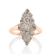 An antique 9ct rose gold ring with marquis shaped paved setting comprising of 15 old cut champagne diamonds mounted in 18ct white gold, circa 1900, size N, 3.8 grams