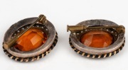 A pair of antique lapel brooches, set with cut citrines and seed pearls mounted in gold with black enamel banding, 19th century, most likely a tiara conversion, each 2.5cm wide - 2