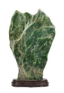 An impressive Chinese jadeite scholar's stone on carved wooden base, 52cm high overall