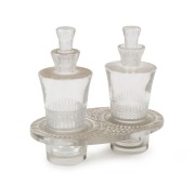 LALIQUE&nbsp;for WORTH &nbsp;French Art Deco&nbsp;two bottle perfume&nbsp;set in stand, circa 1930, stand acid etched "R. LALIQUE, FRANCE", the bottles 12.5cm high, the stand 3.5cm high, 15cm wide