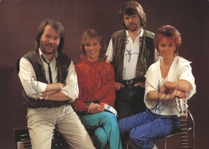 ABBA signatures from all four band members in blue pen on 1982 promotional photo postcard. 14.5cm x 10.5cm overall. 