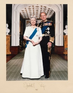 ELIZABETH II AND PRINCE PHILIP signatures in black ink on mounted framed colour photograph, dated 1995. 59 x 71cm overall.