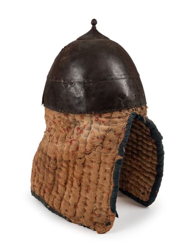 SUDANESE HELMET, with an attached padded section; with a few repairs, damage & wear to the skull. An early helmet that may well date from the 17th Century.