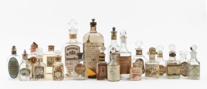 Twenty assorted antique French and English perfume and cosmetic bottles, all with original lithograph paper labels (some with contents), 19th and early 20th century, the largest 21cm high