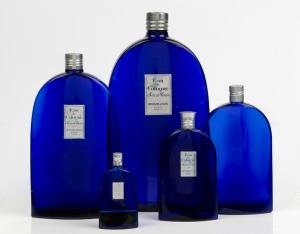 BOURJOIS group of five graduated blue French glass bottles, 20th century, the largest 27.5cm high