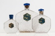 LE NARCISSE BLEU for MURY group of three graduated French glass perfume bottles, two with blue glass stoppers, the other with blue bakelite lid, the largest 18.5cm high