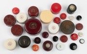 Twenty nine assorted circular powder and ointment pots, bakelite and plastic, 20th century, 11.5cm diameter