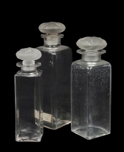 LALIQUE for COTY group of three French glass perfume bottles in three sizes, the largest 17cm high