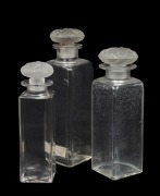 LALIQUE for COTY group of three French glass perfume bottles in three sizes, the largest 17cm high