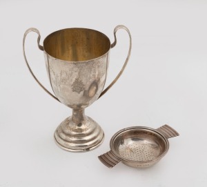 A vintage English sterling silver trophy cup, together with a sterling silver tea strainer, early 20th century, (2 items), the cup 15.5cm high, 192 grams total