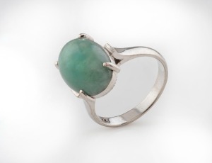 A 14ct white gold and jade ring, stamped "14K", 4.7 grams