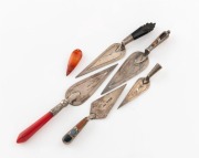 Five assorted antique silver trowel shaped bookmarks with ornate agate, coral and jet handles, 19th century, the largest 10.5cm long