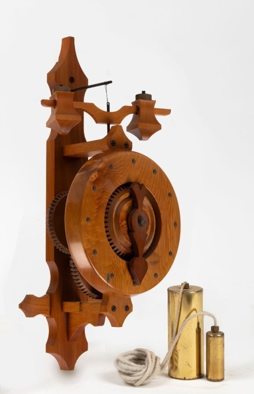 An unusual wooden wall clock with foliot escapement, made from Tasmanian huon pine, circa 2000, 38cm high