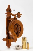 An unusual wooden wall clock with foliot escapement, made from Tasmanian huon pine, circa 2000, 38cm high