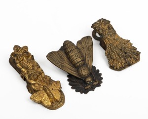Three antique English gilt metal document clips, two bearing diamond pattern registration marks, 19th century, the largest 10.5cm high