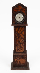An antique poker work pocket watch stand in the form of a grandfather clock; together with an antique sterling silver pocket watch with fusee movement, 19th century, 32cm high