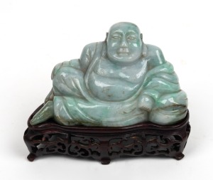 An antique Chinese carved jade Buddha statue on carved wooden stand, 18th/19th century, ​​​​​​​10cm high overall, 12cm wide&nbsp;
