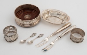 A sterling silver coaster, two sterling silver napkin rings, a pierced silver dish, two salt spoons and two silver handled forks, 19th and 20th century, (8 items), the coaster 9cm diameter
