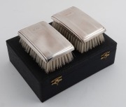 A boxed three piece sterling silver brush set&nbsp;in the Art Deco style, engraved with ownership monogram "W. L.", 20th century, the box 20cm wide - 2