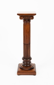 An Italian classical Ionic timber pedestal with square top, conforming base and stop-fluted trunk, mid 20th century, 91cm high, 26cm wide, 26cm deep