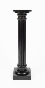 An ebonised pedestal with square top, conforming plinth base and turned and fluted trunk, 106.5cm high, 25.5cm wide, 25.5cm deep