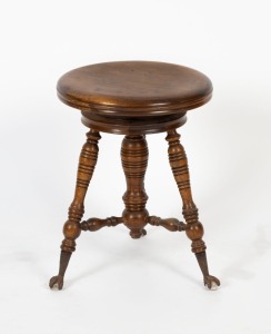 An antique American revolving piano stool with cast iron and glass claw feet, late 19th century, ​​​​​​​47cm high