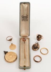 Three gold rings, an antique gold stickpin set with rubies and seed pearls, a gold "Good Luck" pendant and two antique lockets, (7 items)