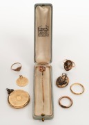 Three gold rings, an antique gold stickpin set with rubies and seed pearls, a gold "Good Luck" pendant and two antique lockets, (7 items)