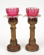 A pair of brass based lamps with ruby glass shades, 19th century, 24cm high