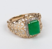 A 9ct gold filigree work ring, set with an attractive natural emerald surrounded by brilliant cut diamonds mounted in white gold, 20th century, 3.2 grams total