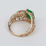 A 9ct gold filigree work ring, set with an attractive natural emerald surrounded by brilliant cut diamonds mounted in white gold, 20th century, 3.2 grams total - 2